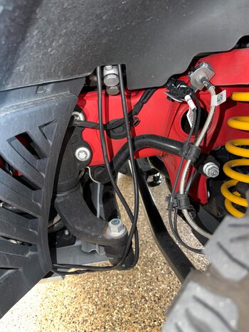 DriverWheelWellCableHanging.jpeg